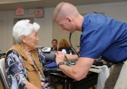 Staff Sgt. Nick Crouse, a medical technician with the 193rd Special Operations Wing's Medical Group out of Middletown, Pa., takes the blood pressure of a patient.